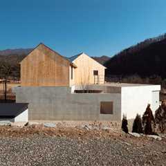 Kissing Gables Perched Atop a Plinth Form a Retired Couple’s Home in South Korea