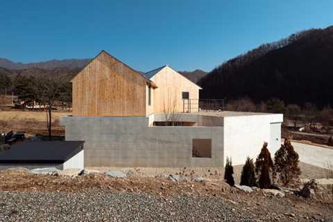 Kissing Gables Perched Atop a Plinth Form a Retired Couple’s Home in South Korea